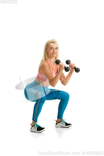 Image of Beautiful female fitness coach practicing isolated on white studio background