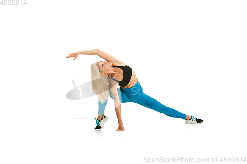 Image of Beautiful female fitness coach practicing isolated on white studio background