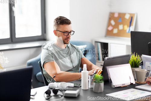 Image of man with laptop computer working at office