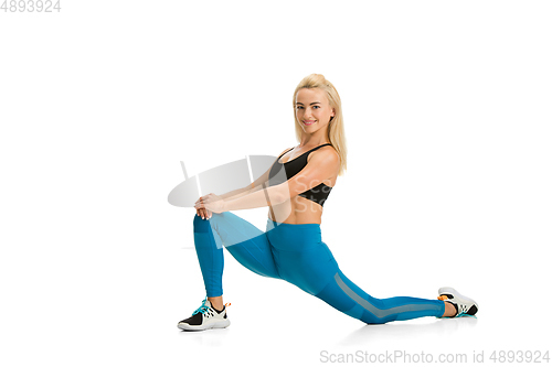 Image of Beautiful female fitness coach practicing isolated on white studio background