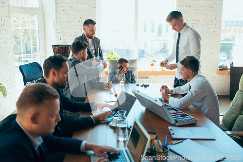 Image of Happy colleagues having fun in office while their colleagues working hard