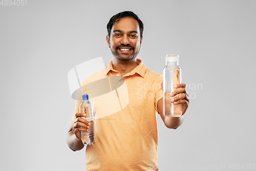 Image of indian man comparing water in different bottles