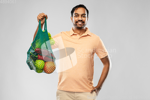 Image of happy indian man with food in reusable net tote