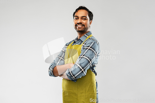 Image of happy indian male gardener or farmer in apron