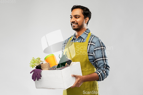 Image of indian gardener or farmer with box of garden tools