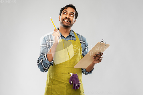 Image of indian gardener or farmer with clipboard thinking