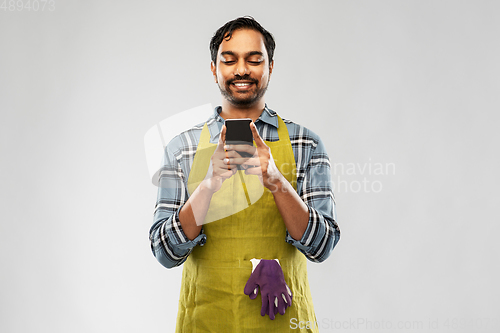 Image of indian male gardener or farmer with smartphone