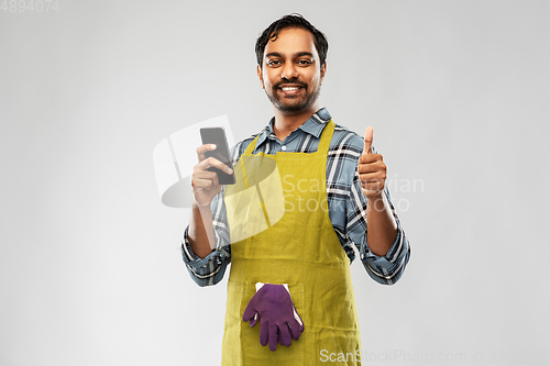 Image of indian male gardener or farmer with smartphone