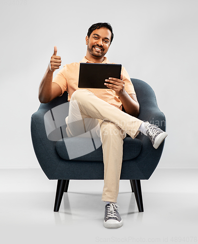 Image of happy indian man with tablet pc showing thumbs up