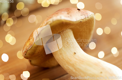 Image of boletus edulis mushroom on wooden background