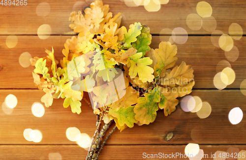 Image of oak leaves in autumn colors on wooden table