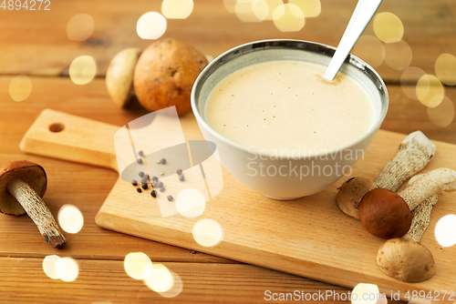 Image of mushroom cream soup in bowl on cutting board