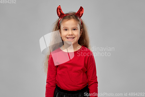 Image of girl in halloween costume and devil's horns