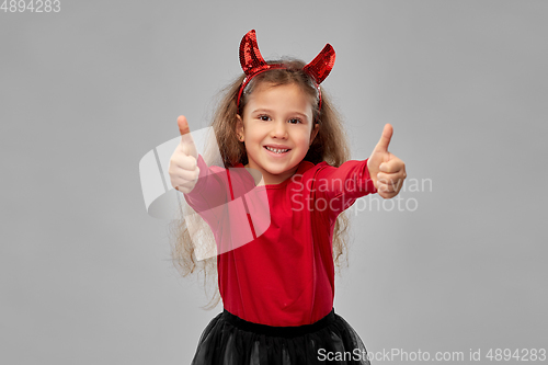 Image of girl in black dress and devil's horns on halloween