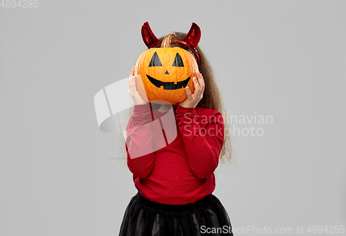 Image of girl in halloween costume with jack-o-lantern