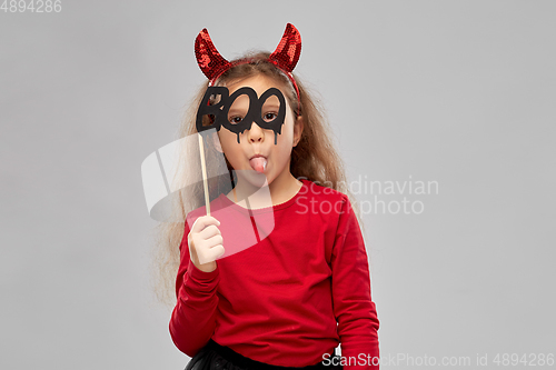 Image of girl in halloween costume with party accessory