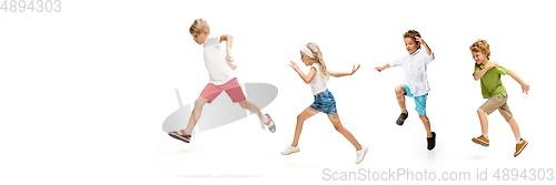 Image of Happy little caucasian kids jumping and running isolated on white background