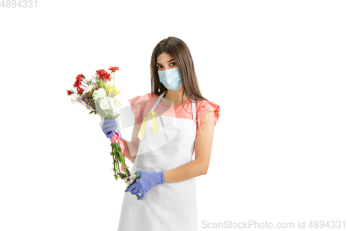 Image of Young woman, florist with bouquet isolated on white studio background