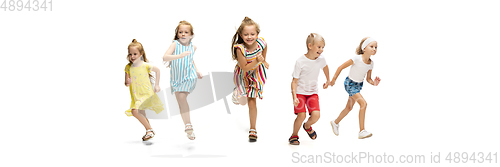 Image of Happy little caucasian kids jumping and running isolated on white background