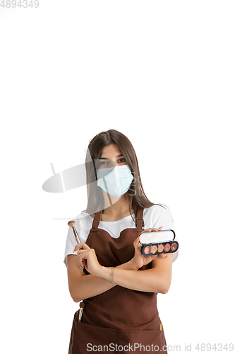 Image of Young woman, visagiste with cosmetics isolated on white studio background