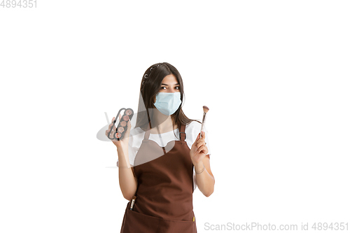 Image of Young woman, visagiste with cosmetics isolated on white studio background