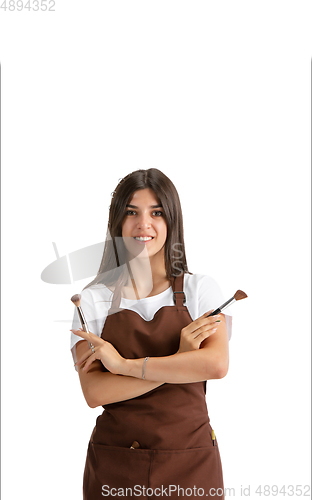 Image of Young woman, visagiste with cosmetics isolated on white studio background