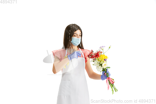 Image of Young woman, florist with bouquet isolated on white studio background