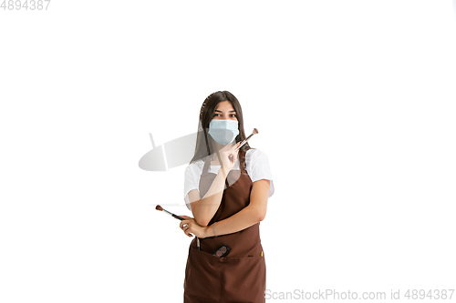 Image of Young woman, visagiste with cosmetics isolated on white studio background