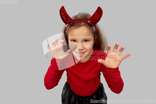 Image of girl costume with devil's horns on halloween