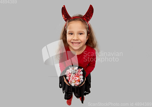 Image of girl with horns trick-or-treating on halloween