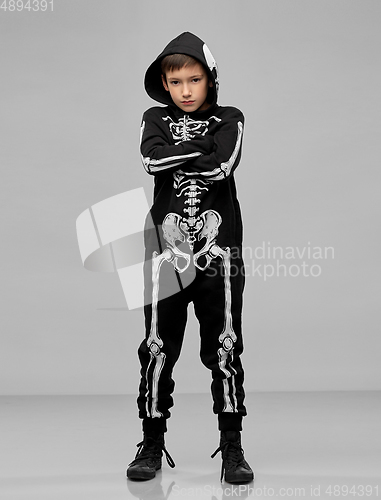 Image of boy in black halloween costume with skeleton bones