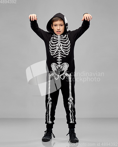 Image of boy in halloween costume of skeleton making faces