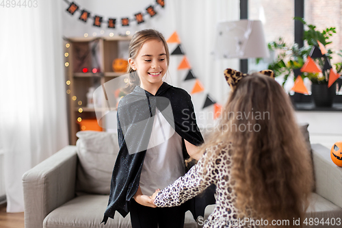 Image of girls in halloween costumes dancing at home