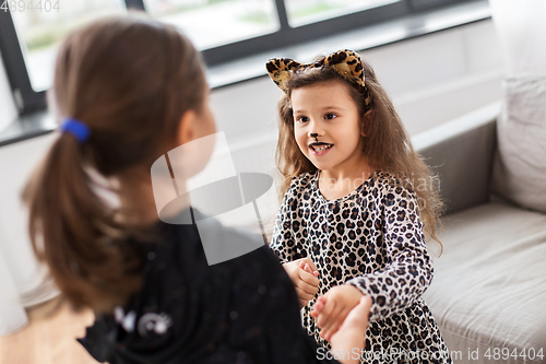 Image of girls in halloween costumes dancing at home