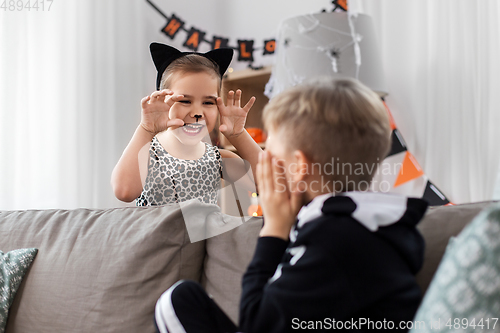 Image of kids in halloween costumes playing at home