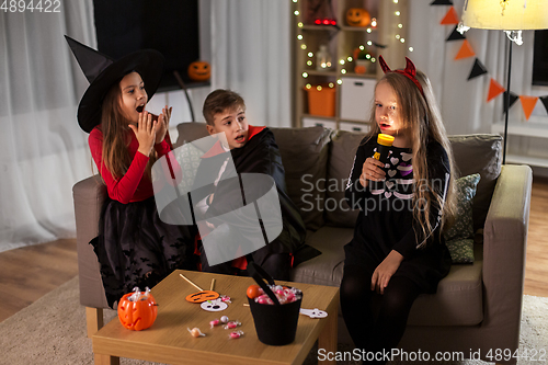 Image of kids in halloween costumes playing at home