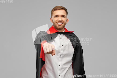 Image of man in vampire cape pointing finger to camera