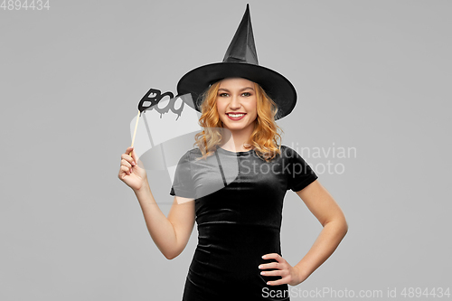 Image of woman in halloween costume of witch with accessory