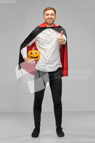 Image of happy man in costume of vampire showing thumbs up