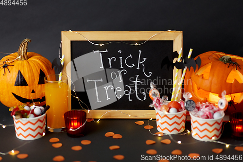 Image of pumpkins, candies and halloween decorations