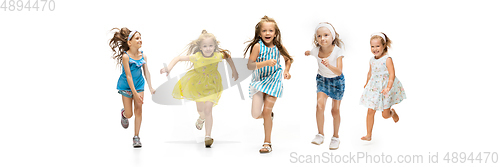 Image of Happy little caucasian kids jumping and running isolated on white background