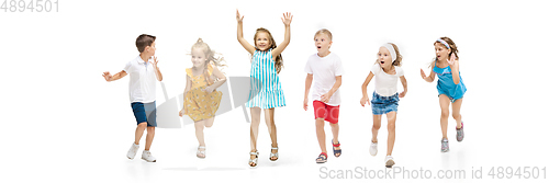 Image of Happy little caucasian kids jumping and running isolated on white background