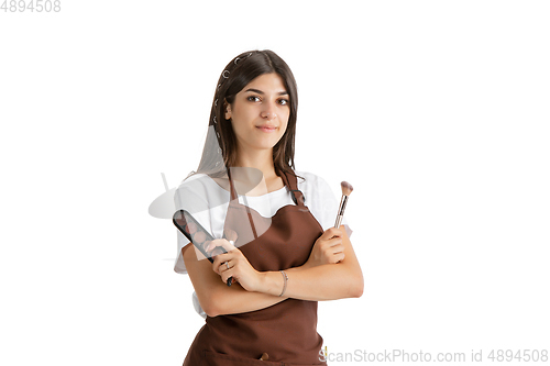 Image of Young woman, visagiste with cosmetics isolated on white studio background