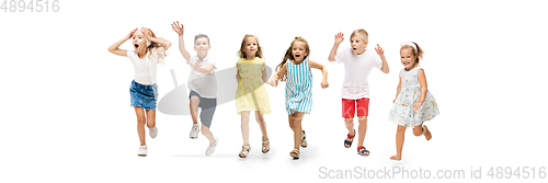 Image of Happy little caucasian kids jumping and running isolated on white background
