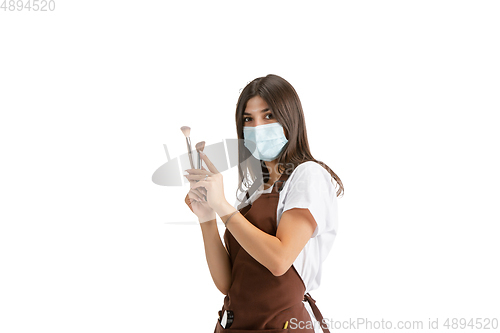 Image of Young woman, visagiste with cosmetics isolated on white studio background