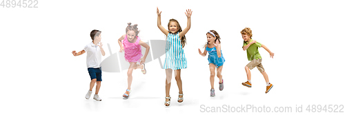 Image of Happy little caucasian kids jumping and running isolated on white background