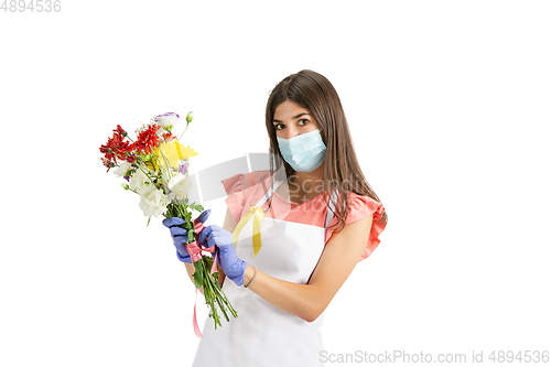 Image of Young woman, florist with bouquet isolated on white studio background