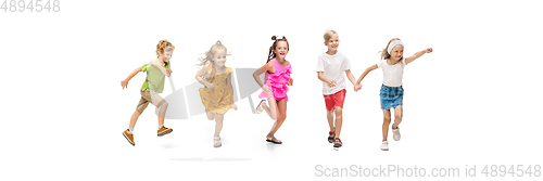 Image of Happy little caucasian kids jumping and running isolated on white background