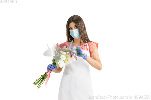 Image of Young woman, florist with bouquet isolated on white studio background