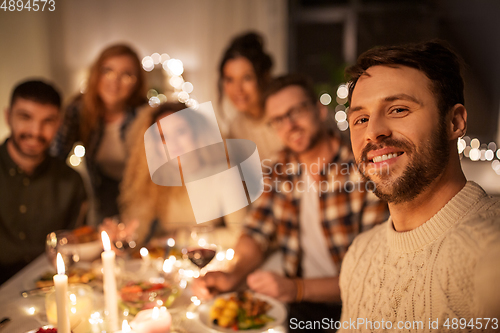 Image of friends taking selfie at christmas dinner party